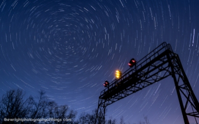 SIGNAL TO THE STARS Twenty-Seven and a half minutes elapse in this collection of four shots layered together as the Pennsy signal bridge at AR (Allegheny Range) stands tall against the backdrop of the swirling night sky and the North Star. This signal stands close to the Pennsylvania Railroad's summit across the Eastern Continental Divide 2,167 feet above sea level and lets eastbound crews know half the journey over the mountains is complete before they enter Portage Tunnel and into "The Slide" and down the mountain.