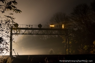 The PRR Position Light Signals at Lilly, PA overnight in October, 2017 as the light from an approaching eastbound pierces through the night air and stars slowly fade. Of note is the contraption to the left center of an old pulley system used by the PRR to allow water to the locomotives since Lilly was a water stop and full interlocking on the West Slope.
