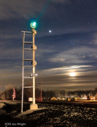 These NY style signals on the former Conrail Lurgan Branch stood until June of 2013. The Moon sets in the distance as an oncoming train approaches.